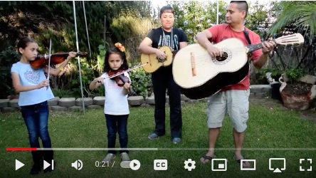 image of the Verdusco Mariachi family performing in their back yard