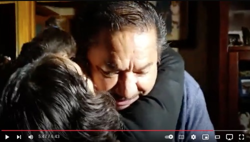 image of daughter hugging dad at his Mariachi birthday surprise